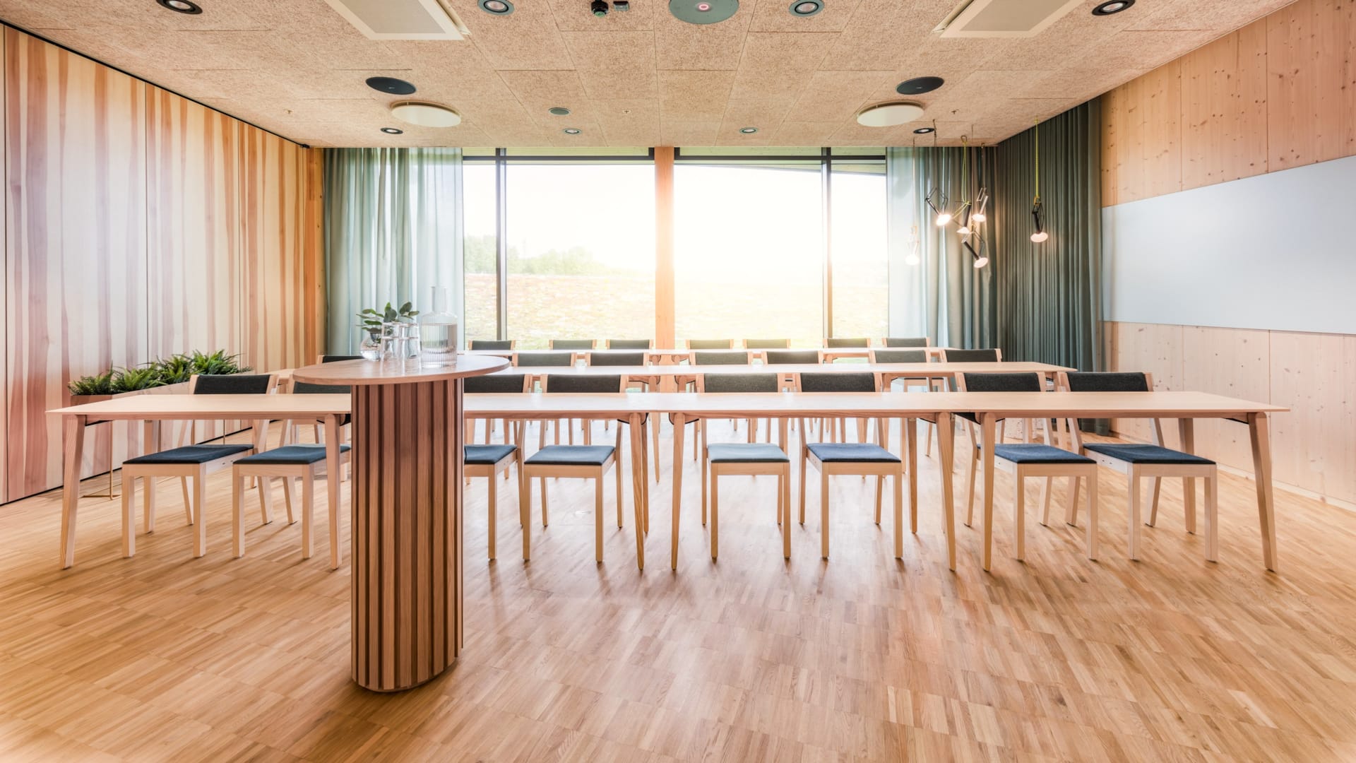 Trees conference room at World of Volvo in Gothenburg, bright room in warm green tones.