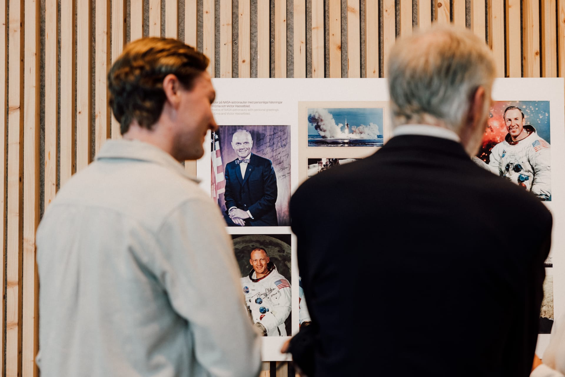 Visitors viewing portraits and photographs of astronauts at the Hasselblad exhibition at World of Volvo in Gothenburg.