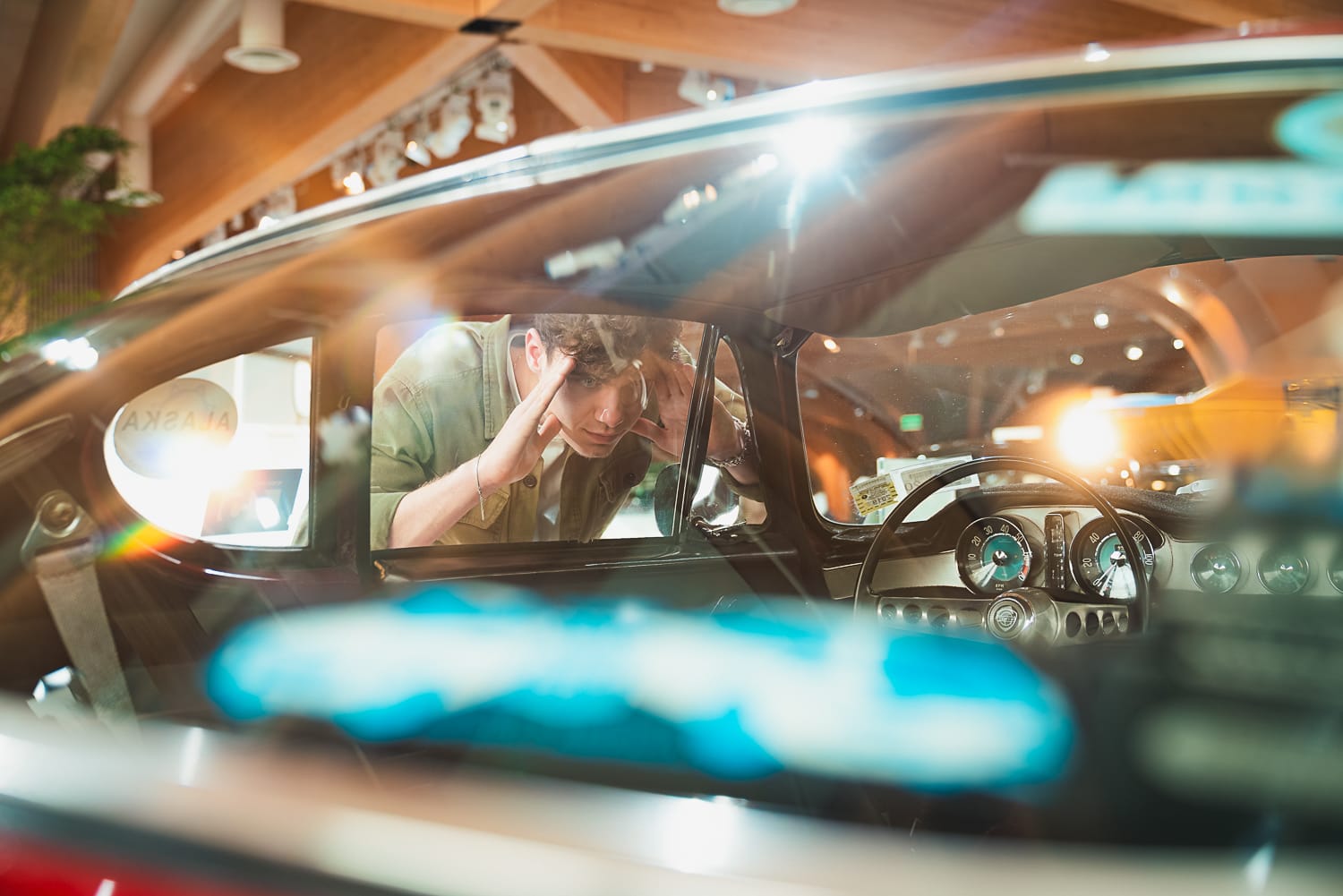 A visitor looking through the window of a volvo car. 